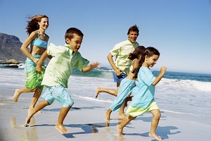 Family running along beach